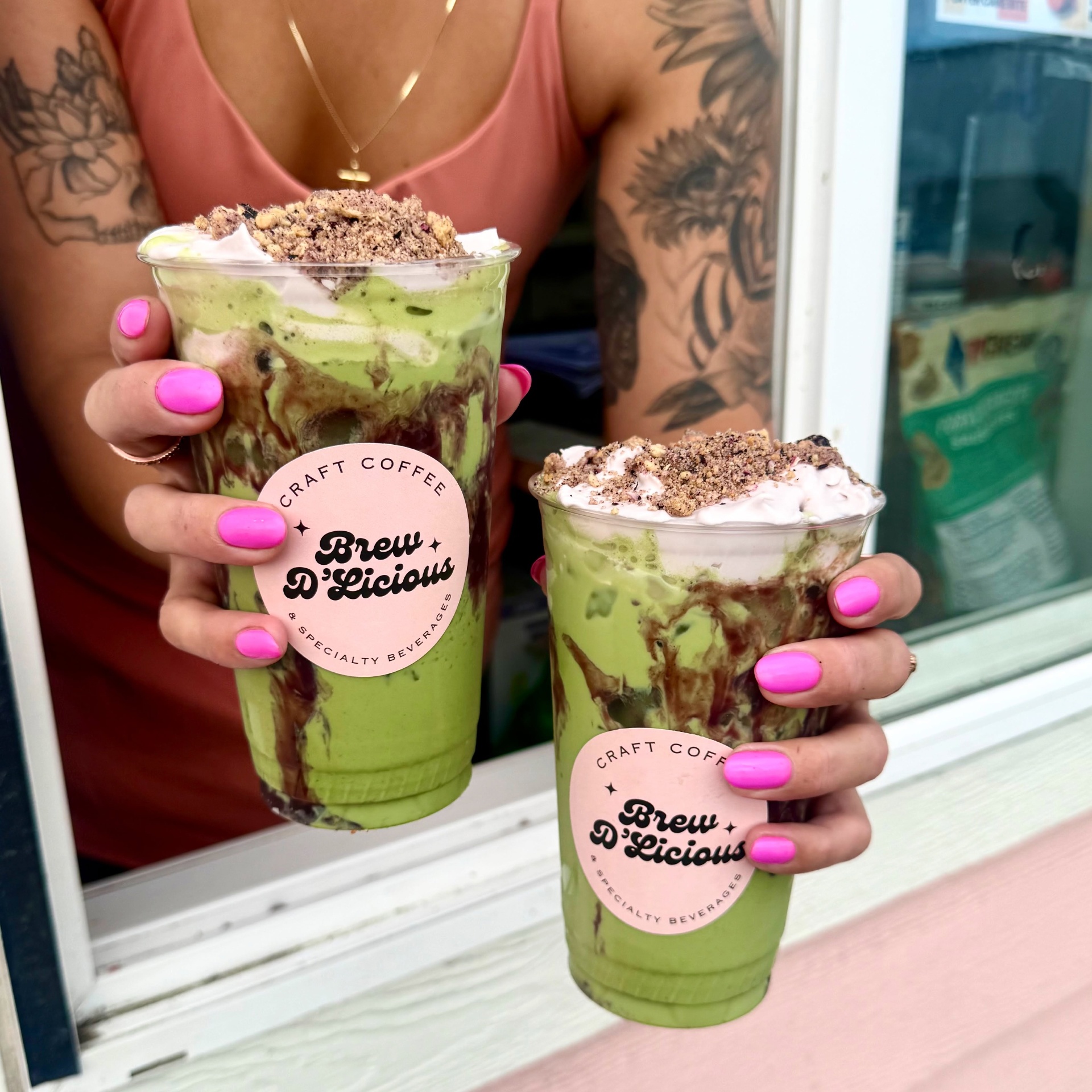Matcha berry crumble held at the pink drive-thru window